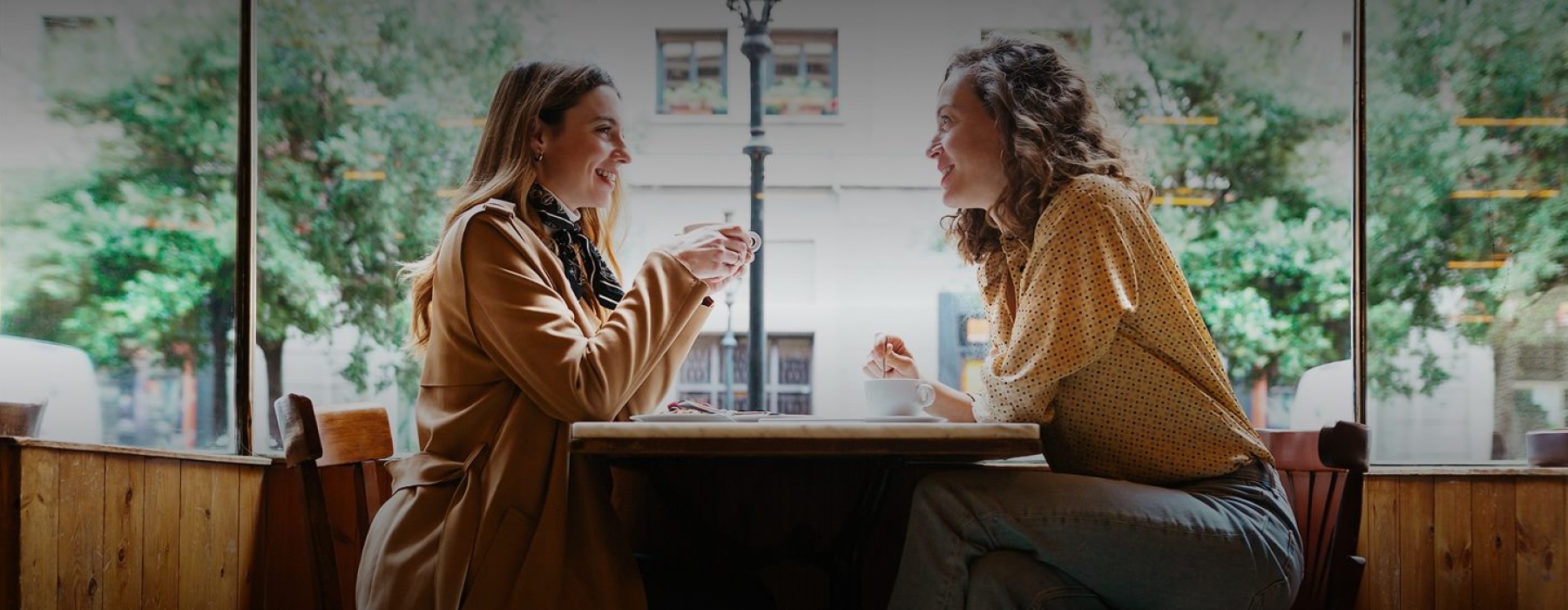 a couple of women sitting at a table