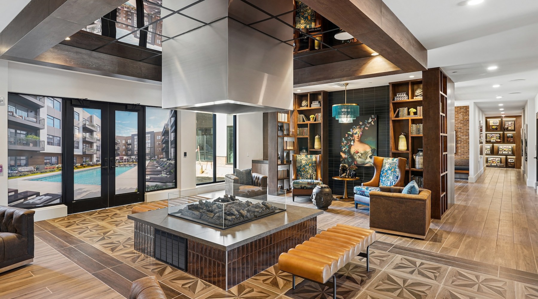lounge with seating fire place and bookshelves
