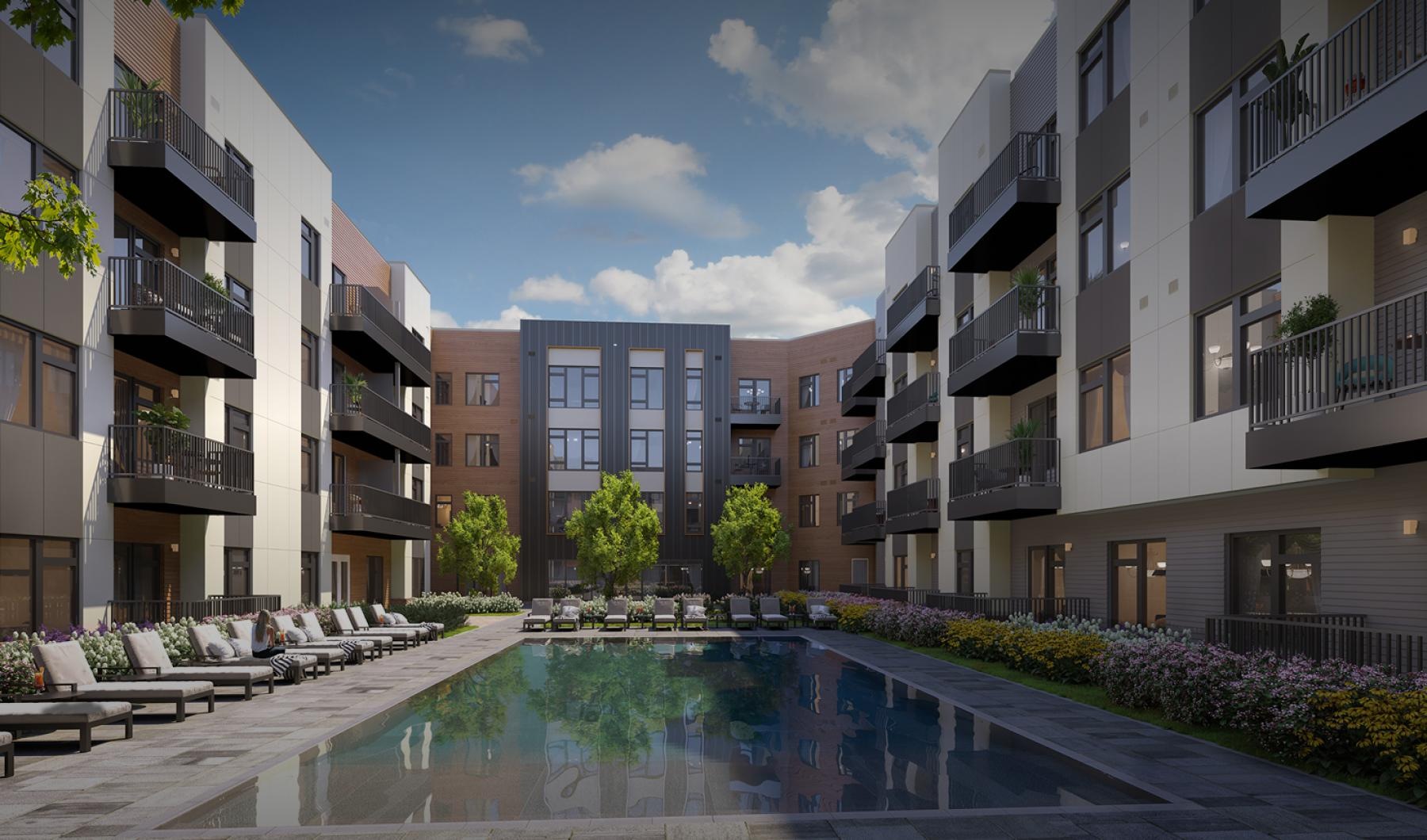 a swimming pool with lounge chairs in a courtyard
