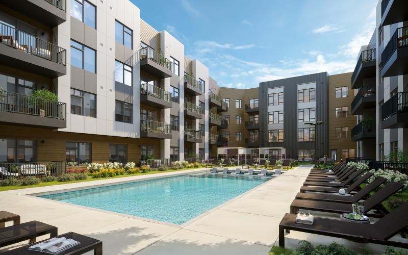 a swimming pool with lounge chairs in a courtyard